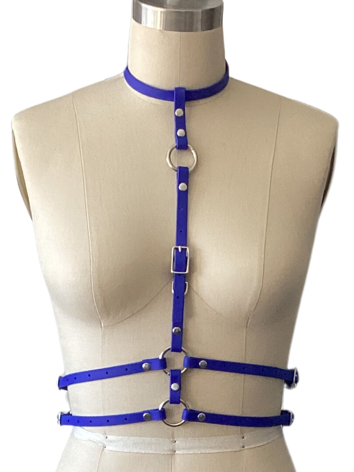 Electric blue harness top outfit on a mannequin against a white wall. 