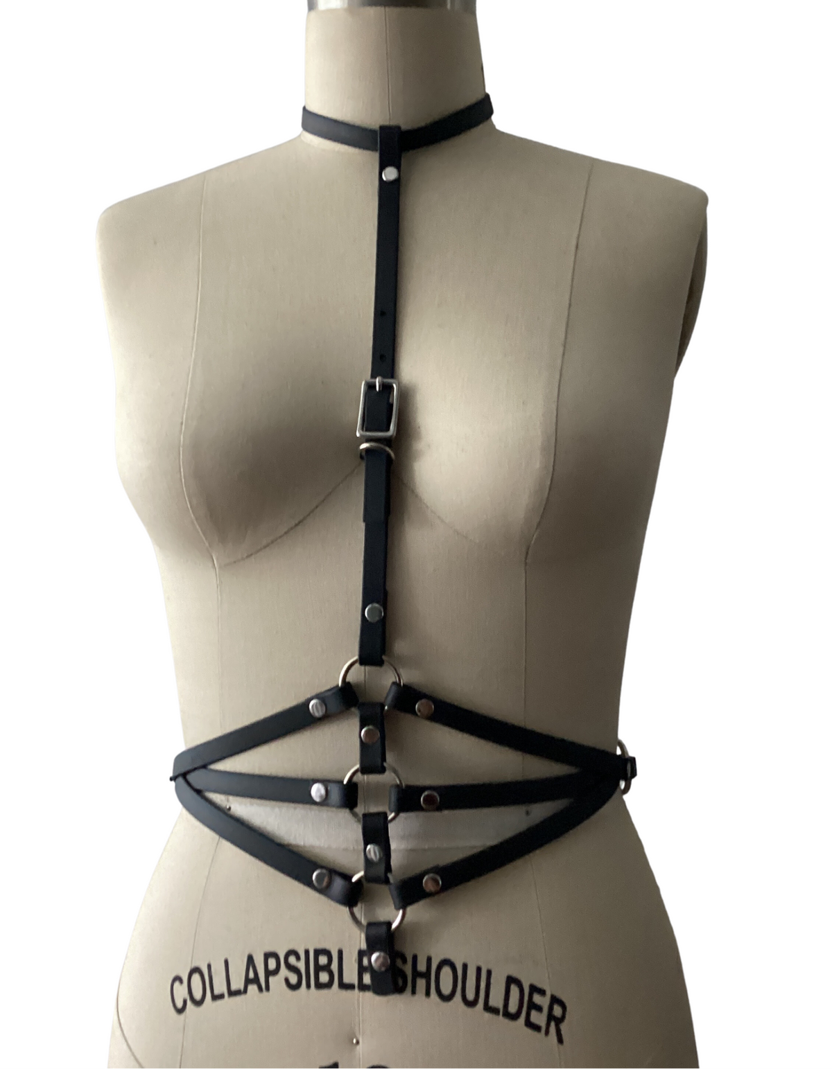 Black harness top outfit for any occasion shown on a mannequin against a white background.