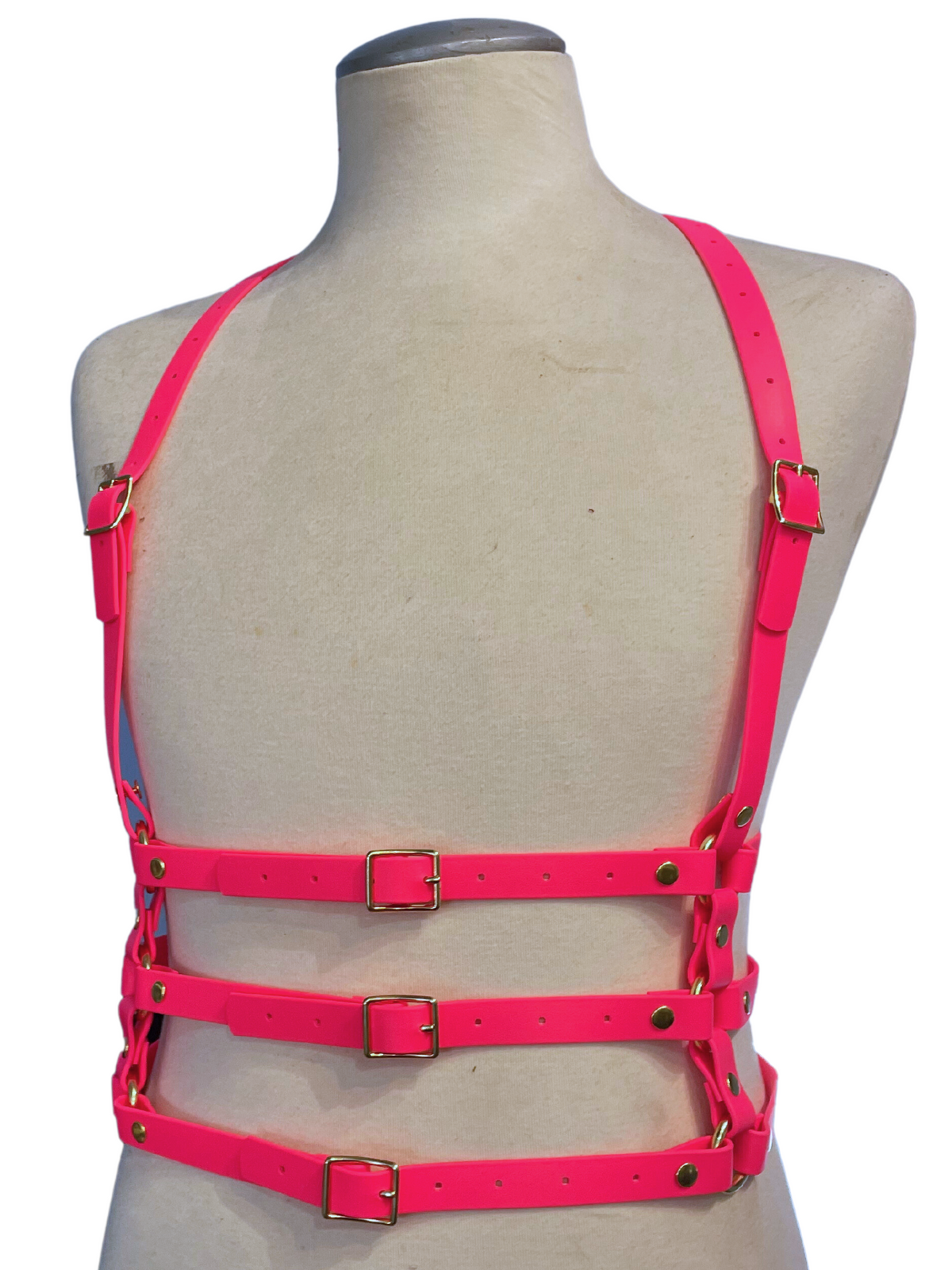 Neon pink vegan leather harness on a mannequin