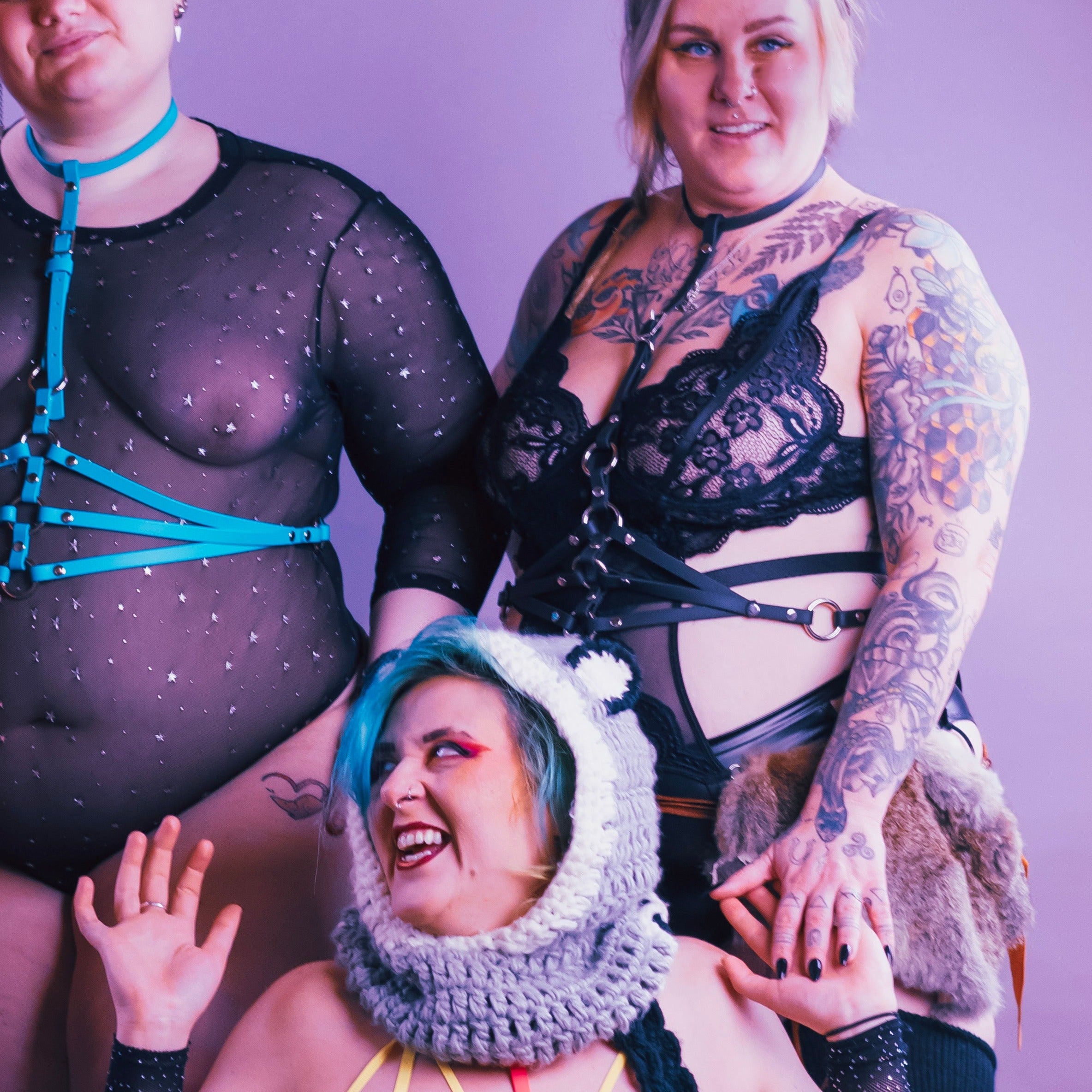Group shot of women modelling colourful vegan leather harnesses.